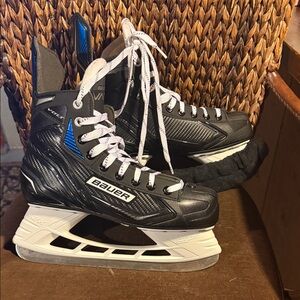 Bauer Black Hockey Skates with Blue Accents and White Holders